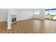 Spacious living room featuring sleek flooring, a modern fireplace, and large windows, seamlessly blending style with comfort at 761 Muturu Rd, Johnstown, CO 80542