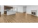 Open-concept living room with a fireplace and connecting dining area and kitchen for seamless entertaining at 761 Muturu Rd, Johnstown, CO 80542