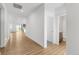 Bright, open-concept living space with hard wood floors and neutral walls with sight lines into the kitchen at 761 Muturu Rd, Johnstown, CO 80542