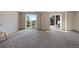 Finished basement space with carpet and sliding glass doors offering outdoor access at 776 Hilltop Rd, Palmer Lake, CO 80133