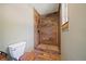 Modern bathroom featuring a wood-tiled shower and stylish toilet at 776 Hilltop Rd, Palmer Lake, CO 80133