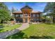 Charming two-story home with a brick walkway, a balcony and a well maintained yard at 776 Hilltop Rd, Palmer Lake, CO 80133