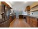 Modern kitchen with stainless steel appliances, wood cabinets and an island at 776 Hilltop Rd, Palmer Lake, CO 80133