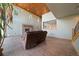 Cozy living room featuring hardwood floors, a stone fireplace and high ceilings at 776 Hilltop Rd, Palmer Lake, CO 80133