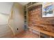 Mud room with built-in wood shelving and a bench seat at 776 Hilltop Rd, Palmer Lake, CO 80133