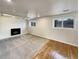 Finished basement recreation room features a fireplace and hardwood floors at 10968 Grange Creek Dr, Thornton, CO 80233