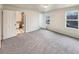 Spacious bedroom with new carpet and access to a full bathroom at 10968 Grange Creek Dr, Thornton, CO 80233