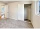 Bright bedroom with grey carpet, a large closet, and an additional door at 10968 Grange Creek Dr, Thornton, CO 80233