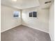 Cozy carpeted bedroom with neutral walls and large windows at 10968 Grange Creek Dr, Thornton, CO 80233