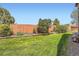 Manicured backyard featuring a lush lawn and wooden fence at 16519 E Hialeah Dr, Centennial, CO 80015
