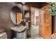 Powder room boasts dark walls, an oval mirror, and a modern sink with vanity at 16519 E Hialeah Dr, Centennial, CO 80015