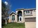 Charming two-story home with arched entryway, beautiful brickwork, and well-manicured lawn at 16519 E Hialeah Dr, Centennial, CO 80015