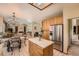 An open kitchen features stainless appliances and access to the Gathering room at 16519 E Hialeah Dr, Centennial, CO 80015
