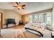 Cozy primary bedroom featuring plush carpet, ceiling fan, a bay window, and seating at 16519 E Hialeah Dr, Centennial, CO 80015