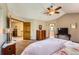 Main bedroom with ceiling fan leads to ensuite bathroom with soaking tub at 16519 E Hialeah Dr, Centennial, CO 80015