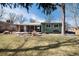Expansive backyard with a patio, mature trees, and ample green space, perfect for outdoor living and recreation at 6930 S Delaware St, Littleton, CO 80120