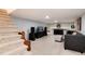 Finished basement with carpet, a fireplace, a gray couch, and a stairwell at 6930 S Delaware St, Littleton, CO 80120