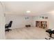 Spacious basement with gray carpet, office chair, bookcase and piano at 6930 S Delaware St, Littleton, CO 80120