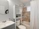 Cozy bathroom featuring warm tiled shower with shower and tub with modern fixtures at 6930 S Delaware St, Littleton, CO 80120