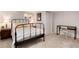 Bedroom with a black metal frame bed, desk, lamps and neutral carpet at 6930 S Delaware St, Littleton, CO 80120