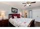 Bedroom features hard wood floors, and a queen sized bed with an ensuite bathroom at 6930 S Delaware St, Littleton, CO 80120