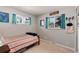 Bedroom featuring two windows with bright curtains and a striped blanket on the bed at 6930 S Delaware St, Littleton, CO 80120