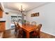 Dining room with hardwood floors, sliding glass door, adjacent to living area at 6930 S Delaware St, Littleton, CO 80120