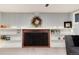 Basement brick fireplace with white shelving, decorations, and a wreath at 6930 S Delaware St, Littleton, CO 80120