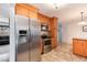 Well lit kitchen with stainless steel appliances including a refrigerator, microwave, and oven at 6930 S Delaware St, Littleton, CO 80120
