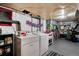 Functional laundry room with washer, dryer, and ample storage shelving for an organized space at 6930 S Delaware St, Littleton, CO 80120