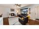 Bright living room features a fireplace, hardwood floors and an abundance of natural light at 6930 S Delaware St, Littleton, CO 80120