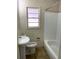 Bathroom with a sink, toilet and shower, and a window for natural light at 945 Zenobia St, Denver, CO 80204