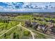 Aerial view of homes and golf course, highlighting the community's layout and recreational amenities at 7658 S Country Club Pkwy, Aurora, CO 80016