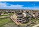Aerial view of home exterior showcasing solar panels, yard, and an outdoor living space at 7658 S Country Club Pkwy, Aurora, CO 80016