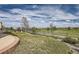 Well maintained backyard with iron fencing, manicured landscaping, and gorgeous views of the neighborhood at 7658 S Country Club Pkwy, Aurora, CO 80016