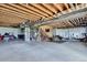 Unfinished basement featuring open ceilings, concrete floor, and ample space for storage or customization at 7658 S Country Club Pkwy, Aurora, CO 80016