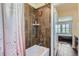 This bathroom features a tiled shower and a bedroom in the background at 7658 S Country Club Pkwy, Aurora, CO 80016