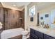 Bathroom features modern fixtures, granite countertops, and tile in shower at 7658 S Country Club Pkwy, Aurora, CO 80016