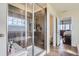 Modern bathroom featuring a glass-enclosed shower and a soaking tub, offering a spa-like experience at 7658 S Country Club Pkwy, Aurora, CO 80016
