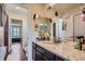 Well-lit bathroom with granite countertops and a view into the bedroom at 7658 S Country Club Pkwy, Aurora, CO 80016