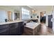 Luxurious bathroom showcasing a soaking tub, double vanity, dark wood cabinets, granite counters, and tiled floor at 7658 S Country Club Pkwy, Aurora, CO 80016