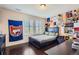 This bedroom is personalized with decor and features a dark wood bed frame and shuttered windows at 7658 S Country Club Pkwy, Aurora, CO 80016