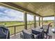 Comfortable covered patio with outdoor seating overlooking the golf course at 7658 S Country Club Pkwy, Aurora, CO 80016