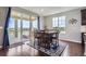 Dining room with large windows, sliding glass door, wood table, and seating for six at 7658 S Country Club Pkwy, Aurora, CO 80016