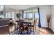 Open dining room with a dark wood table, seating for six, and sliding glass doors to the deck at 7658 S Country Club Pkwy, Aurora, CO 80016