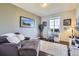Comfortable home office with a large window and comfortable seating at 7658 S Country Club Pkwy, Aurora, CO 80016