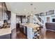 Spacious kitchen with granite countertops, dark wood cabinetry, and an island with bar seating at 7658 S Country Club Pkwy, Aurora, CO 80016