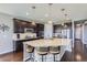 Elegant kitchen with a large island, pendant lighting, and dark wood cabinetry at 7658 S Country Club Pkwy, Aurora, CO 80016