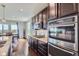 Beautiful kitchen featuring dark wood cabinets, stainless steel appliances and golf course view at 7658 S Country Club Pkwy, Aurora, CO 80016