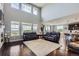 Bright living room with high ceilings, large windows, and a view into the kitchen at 7658 S Country Club Pkwy, Aurora, CO 80016